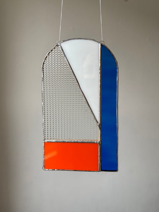 A piece of stained glass hung up 